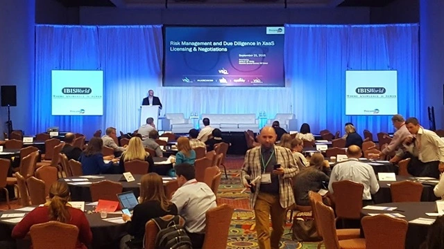 High-fidelity executive keynote stage with IBISWorld branding, demonstrating studio-grade illumination and Delta E < 2.0 color accuracy for 8K broadcast capture.