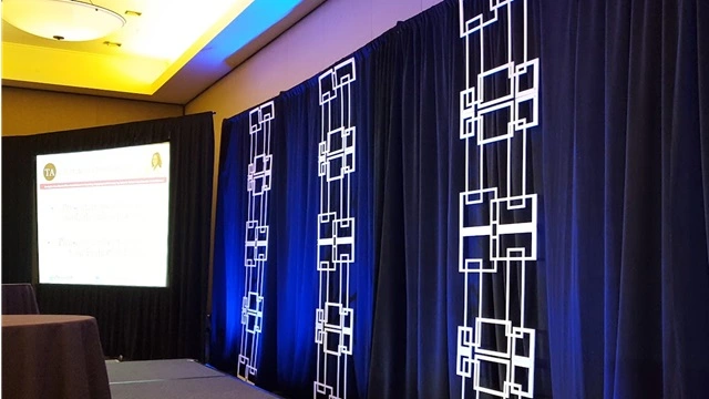 A high-occupancy plenary hall featuring enterprise event set design for ProcureCon West, demonstrating theater-style sightline engineering and synchronized multi-screen brand immersion.
