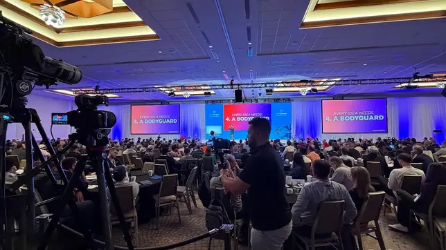 Professional event video production in San Diego capturing a large corporate conference with multi-camera setup, live audience, and stage presentation.